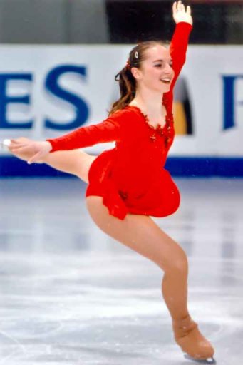 CP on the ice, smiling on the landing of a jump