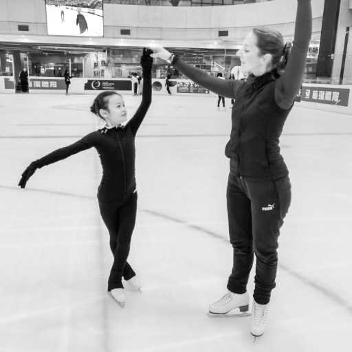 Constanze is fine-tuning the presentation of her skater on the ice; other skaters blurred in the background