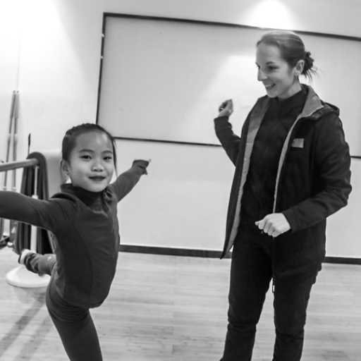 In the dance studio, skater is in the kanding position and Constanze is standing by her side smiling